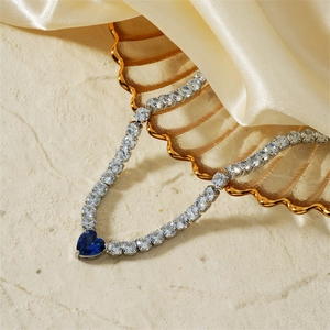 Elegant silver tennis necklace with sparkling white zircons and a deep blue heart pendant