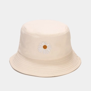 Close-up of the delicate daisy embroidery and premium cotton texture on this beige bucket hat