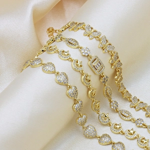 Gold plated bracelets collection with heart and butterfly designs on champagne satin