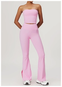 Detail view of pink yoga set showing high-waisted flared pants with side slits