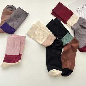 Detailed flat lay of striped cashmere crew socks in assorted vintage color-block patterns