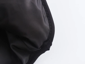Detailed close-up of high-quality black twill fabric lining with durable stitching