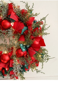 Close-up of 40cm Christmas wreath featuring red bows, LED lights, and berries