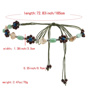 Detail showing bohemian woven green belt with wood petals and stone beads, 185cm length