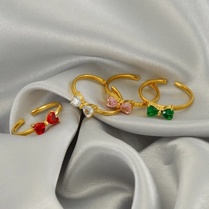 Adjustable bow open rings in gold with red, white, pink and green zircon crystals