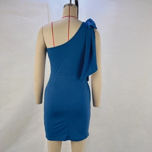 Detail view of the back of a dark blue one-shoulder dress with a bow on the shoulder