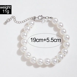 Detail of white pearl bracelet with silver lobster clasp and size markings