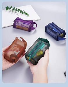 Detail view of mesh storage pouches in purple, dark blue, brown, and green with zippers
