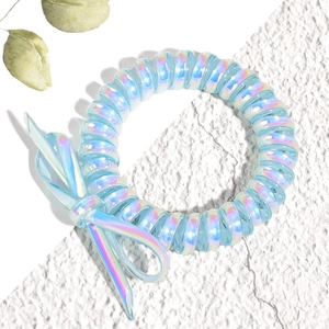 Détail d'un élastique spirale dégradé bleu avec un nœud assorti et fini iridescent
