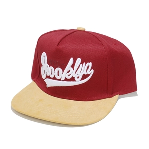Detail view of Brooklyn NYC 3D embroidery on maroon and khaki flat brim snapback hat