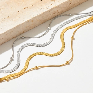 Double layered stainless steel snake and bead necklace set in gold and silver finishes