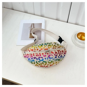 Detail of rainbow leopard sequin pattern and woven texture on a stylish fanny pack