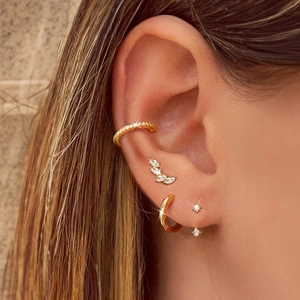 Detail view of S925 silver gold earring set featuring leaf studs and cubic zirconia hoops
