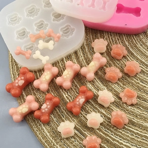 Food-grade silicone molds featuring mini cat paw and dog bone shapes for cake baking