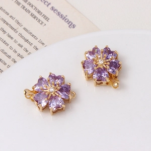 Macro shot of purple cubic zirconia cherry blossom pendants with gold plated clasps