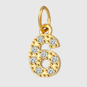 Detailed close-up of golden number six pendant with zircon inlay and hanging loop