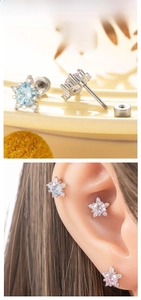 Macro detail of star-shaped zircon earrings with secure threaded titanium screw backs