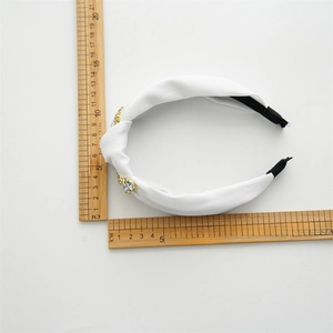 White fabric knotted headband with gold rhinestones measured at sixteen centimeters long