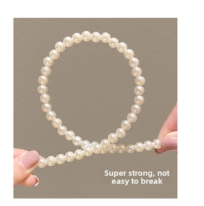 Detail showing the ultra-strong elasticity and durability of white pearl hair accessories