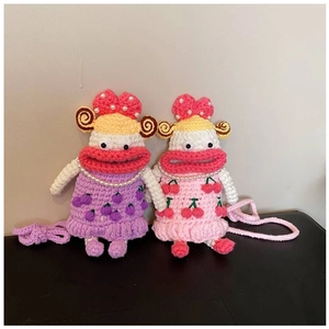 Close-up of handmade crochet sausage mouth bags with cherry and grape dress patterns