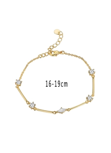Detailed macro view of gold plated bracelet featuring marquise and round cubic zirconia