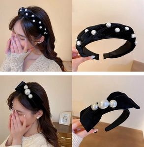 Detail of vintage black velvet headband with woven twist texture and pearl embellishments