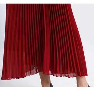 Close-up of red pleated chiffon maxi dress showing detailed fabric texture and drape