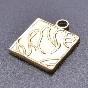 Macro view of square 18k gold plated stainless steel pendant with tulip engraving