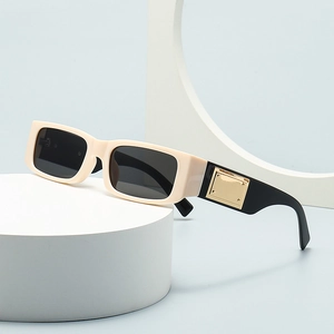 Modern rectangular sunglasses in cream white with black temples and gold metal accents