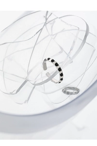 Detailed view of S925 sterling silver ring with black enamel dots on glass shards