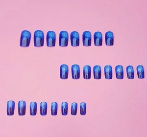 Detailed flat lay of 24 blue gradient press-on nails with white lightning patterns