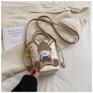 Close-up of cream crossbody bucket bag with 3D bunny decor and retro print details
