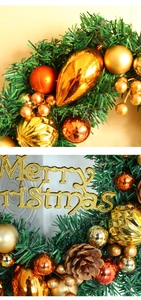 Detail of Christmas wreath with golden ornaments, pine cones, and Merry Christmas sign