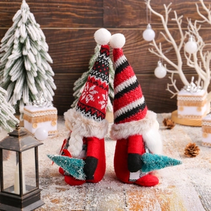 Charming red and black Christmas gnomes with knit hats and plush beards in festive decor