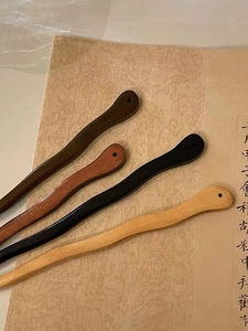 Détail de quatre épingles à cheveux en bois de santal sur papier de calligraphie