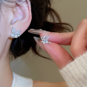 Close-up of elegant silver butterfly stud earrings with sparkling cubic zirconia stones
