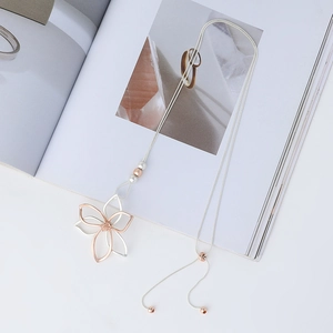 Detail of bicolor hollow flower pendant with sleek snake chain and adjustable bead