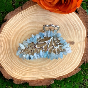 Detailed view of silver butterfly hair claw clip with light blue natural crystal stones