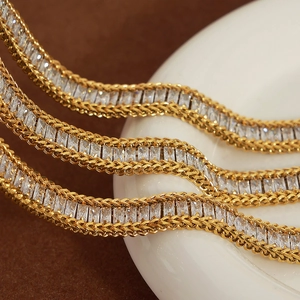 Elegant gold titanium bracelet with baguette-cut zircon stones and wheat-link chain