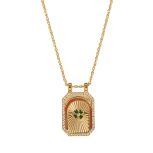 Close-up of a gold octagonal pendant featuring a green clover center and zircon halo