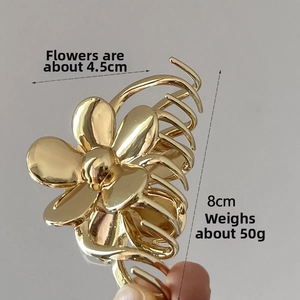 Detailed size view of the 8cm gold flower hair claw clip with a 4.5cm floral motif