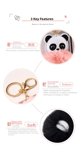 Macro shot of plush panda keychain detailing metal lobster clasp and pink fur texture