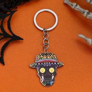 Acrylic floral skull keychain with straw hat for Halloween on orange background
