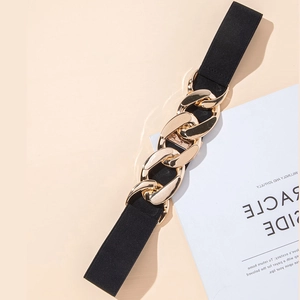 Detail of black elastic waist belt with a chunky gold chain buckle for dresses