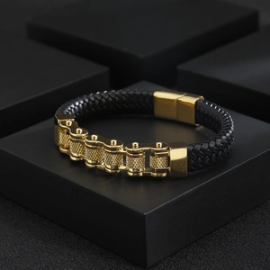 Men's punk leather bracelet with gold bike chain links on black geometric stands