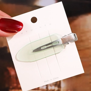 Detail showing a 6cm light green translucent acetate hair clip with a silver metal base
