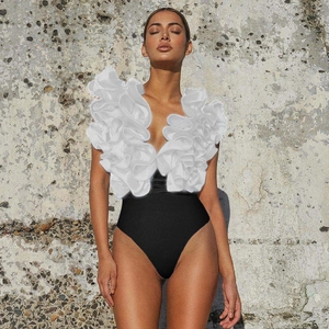 Detailed view of swimwear with elegant white ruffled V-neckline and slim black high-waist fit