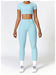 Close-up of light blue high-waist yoga leggings and short sleeve crop top gym set