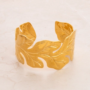 Detail view of the intricate leaf texture on the gold-plated stainless steel cuff bracelet