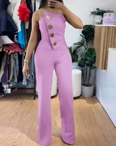 Detailed view of pink strapless jumpsuit with four decorative gold buttons on the front